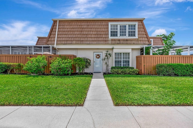 view of property featuring a front lawn