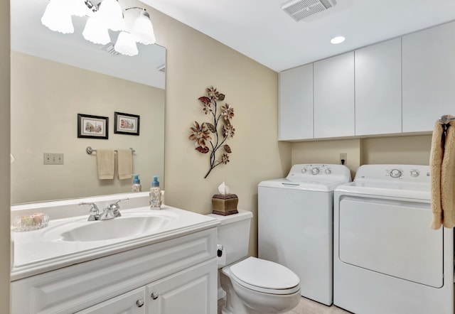 bathroom with vanity, toilet, and washing machine and clothes dryer