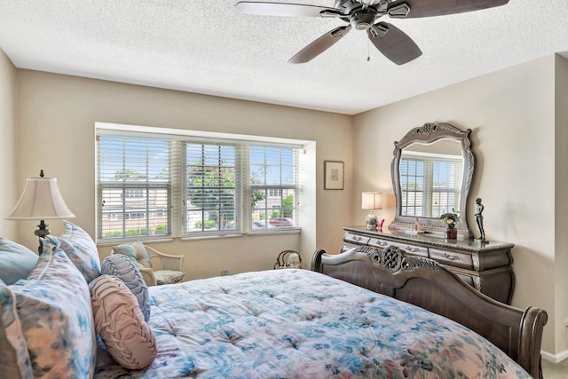 bedroom featuring ceiling fan, a textured ceiling, and multiple windows