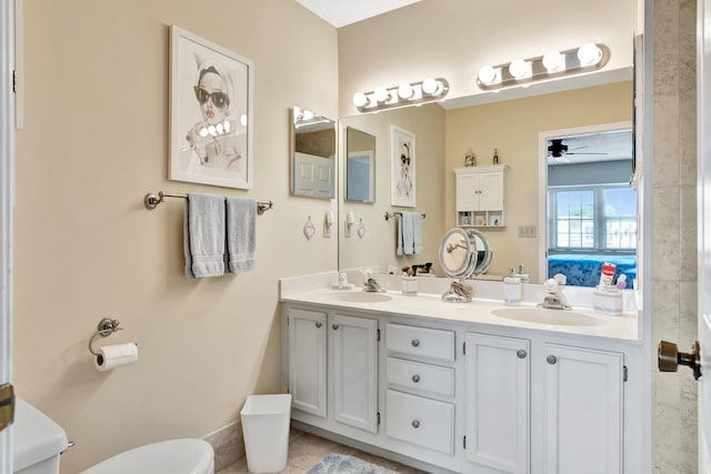 bathroom with ceiling fan, vanity, tile patterned flooring, and toilet