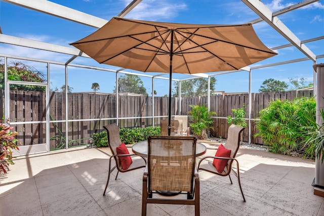 view of patio with glass enclosure