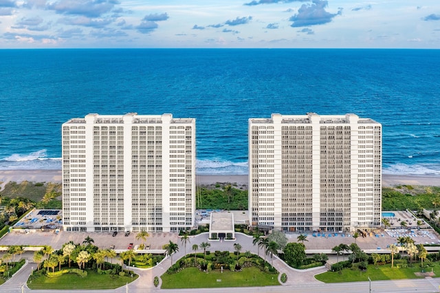 drone / aerial view with a water view and a beach view