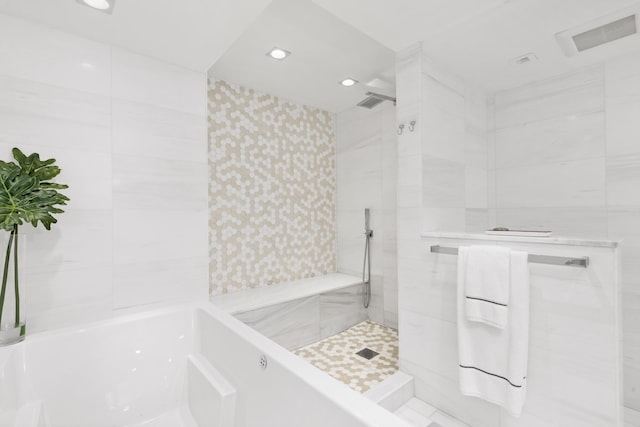 bathroom featuring separate shower and tub and tile walls