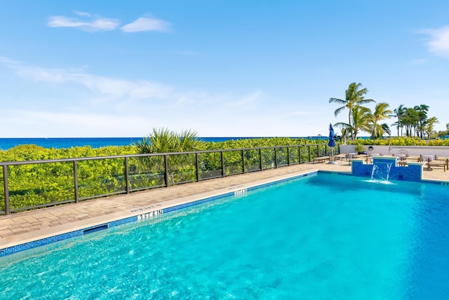 view of swimming pool with a water view