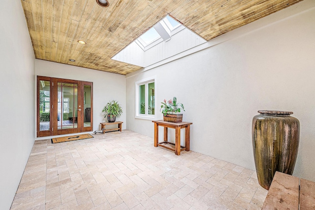 sitting room featuring light hardwood / wood-style flooring, a skylight, and ornamental molding