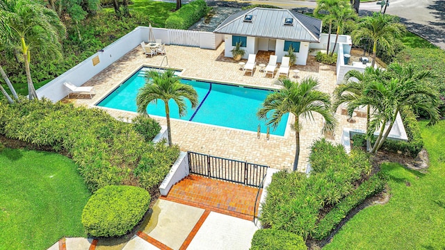 18587 SE Ferland Ct, Jupiter, FL 33469 - community pool featuring a storage structure, a patio area, a fenced backyard, and an outdoor structure