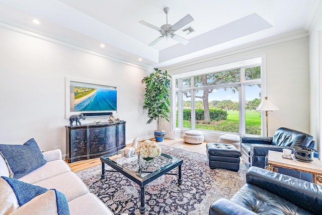 18587 SE Ferland Ct, Jupiter, FL 33469 - living area with ornamental molding, a raised ceiling, ceiling fan, visible vents, and wood finished floors