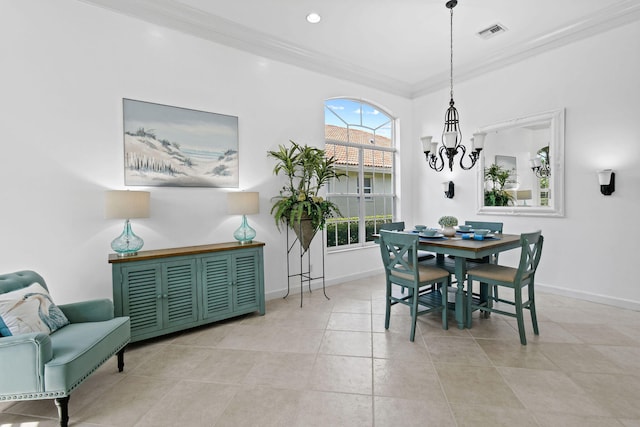 dining room with an inviting chandelier, crown molding, and light tile patterned flooring