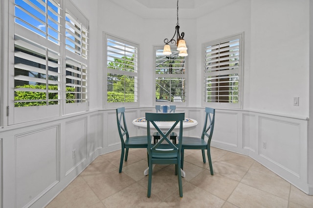 dining room featuring light tile patterned flooring and a notable chandelier