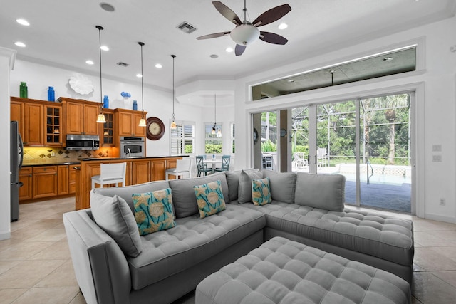 living room featuring a high ceiling, a ceiling fan, recessed lighting, light tile patterned floors, and visible vents