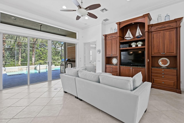 tiled living room with crown molding and ceiling fan