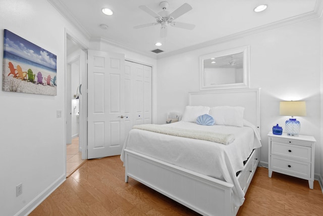 bedroom featuring ornamental molding, a closet, light hardwood / wood-style floors, and ceiling fan