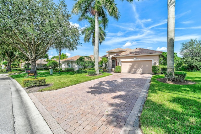 view of front facade with an attached garage, stucco siding, a front yard, decorative driveway, and a tiled roof