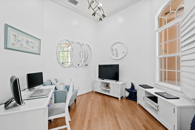 home office with light hardwood / wood-style flooring and a chandelier