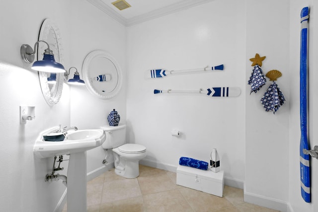 bathroom featuring visible vents, crown molding, toilet, baseboards, and tile patterned floors