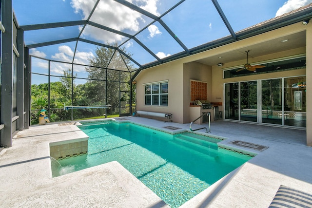 view of swimming pool with glass enclosure, ceiling fan, and a patio area