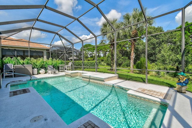 outdoor pool featuring a patio, glass enclosure, and a jacuzzi