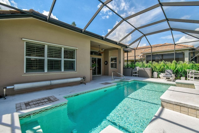 outdoor pool featuring a patio, a ceiling fan, and glass enclosure