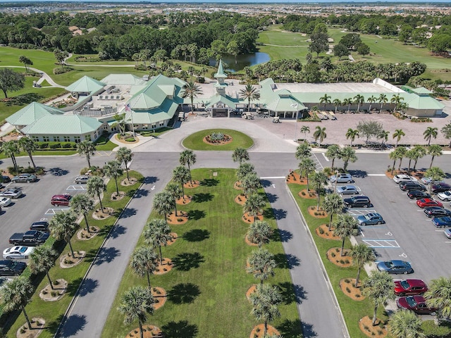 drone / aerial view with a water view and golf course view