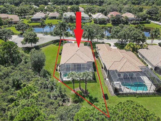 drone / aerial view featuring a residential view and a water view