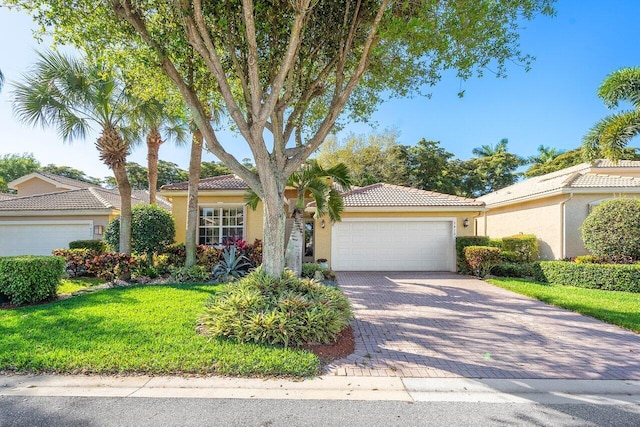 view of front of property with a garage and a front yard