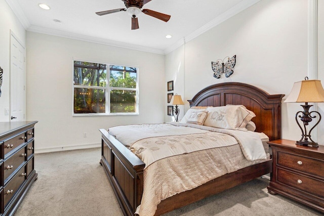 carpeted bedroom featuring ceiling fan and crown molding