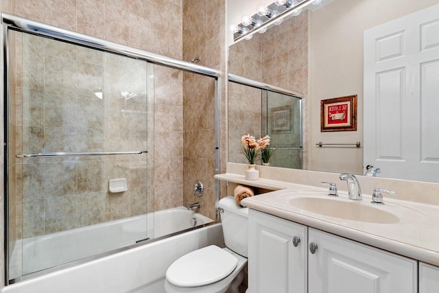 full bathroom with combined bath / shower with glass door, vanity, and toilet