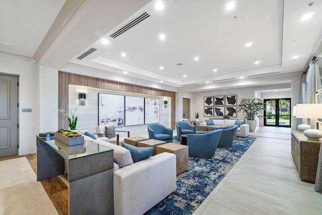 living room featuring light hardwood / wood-style flooring and a tray ceiling