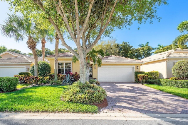 view of front of house with a garage and a front yard