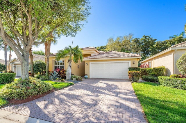 mediterranean / spanish-style house with a garage