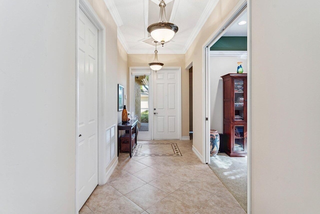 carpeted entryway featuring ornamental molding