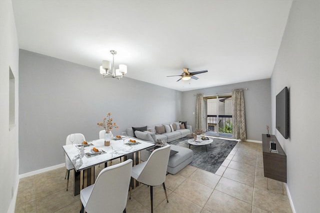 dining area featuring ceiling fan with notable chandelier and light tile patterned floors