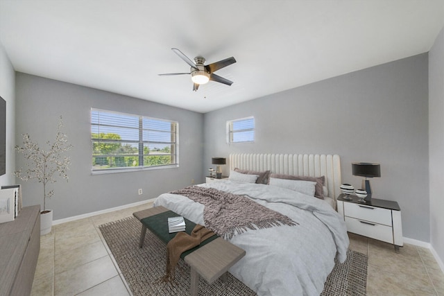 tiled bedroom featuring ceiling fan