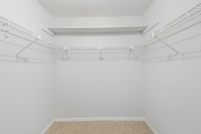 spacious closet featuring light tile patterned flooring