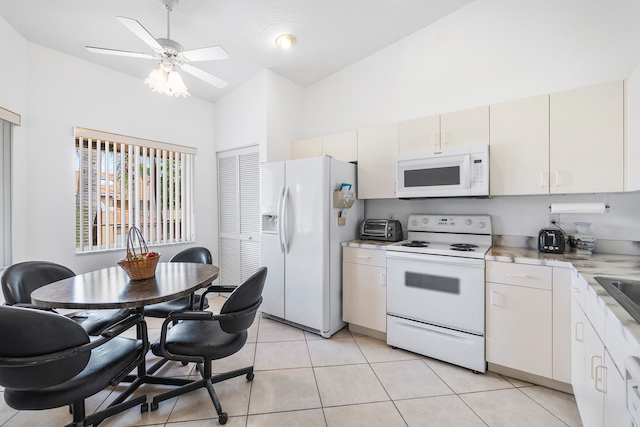 kitchen featuring light tile patterned flooring, white cabinetry, high vaulted ceiling, white appliances, and ceiling fan