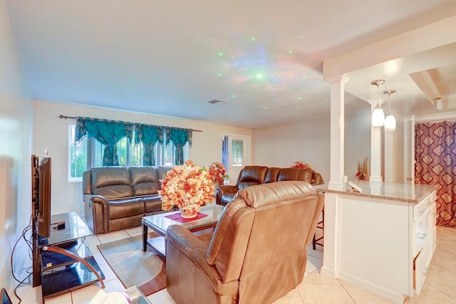 tiled living room featuring decorative columns