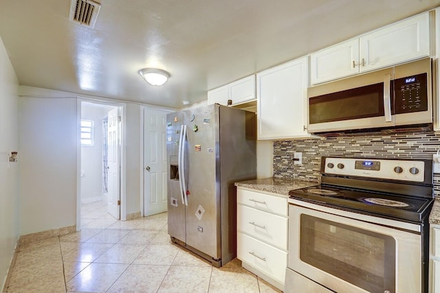 kitchen featuring baseboards, visible vents, white cabinetry, decorative backsplash, and appliances with stainless steel finishes