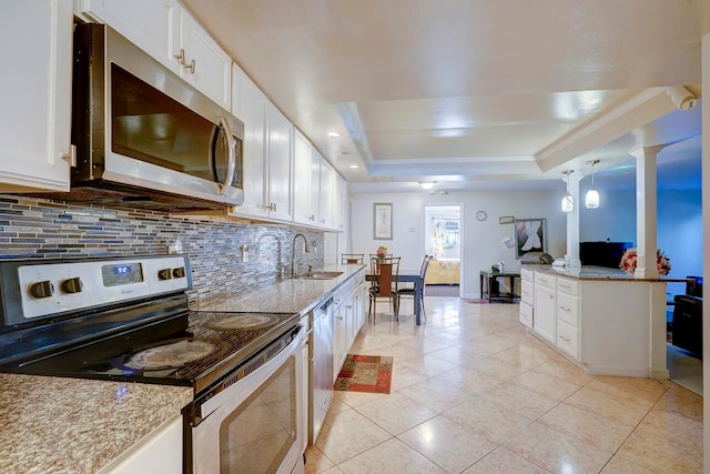 kitchen featuring white cabinets, pendant lighting, a raised ceiling, sink, and appliances with stainless steel finishes