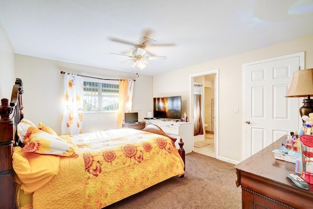 bedroom with ceiling fan, ensuite bath, carpet flooring, and visible vents