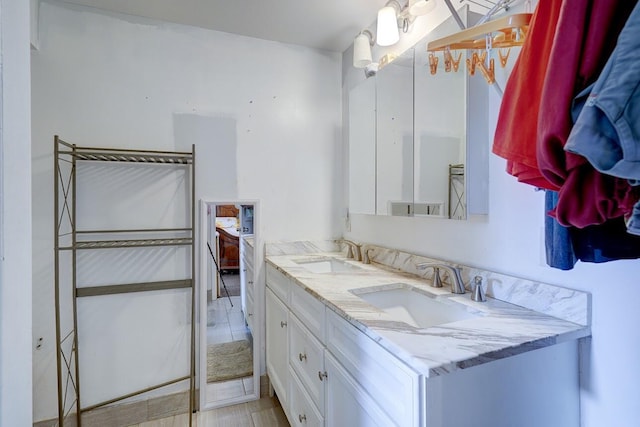 bathroom featuring a sink and double vanity