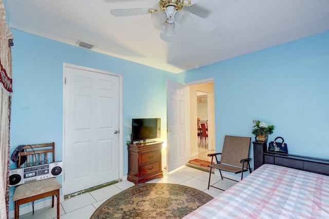 bedroom with ceiling fan, visible vents, and light tile patterned floors