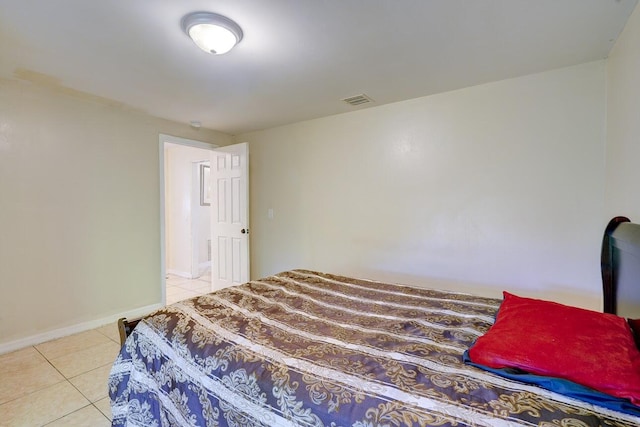 tiled bedroom with baseboards and visible vents