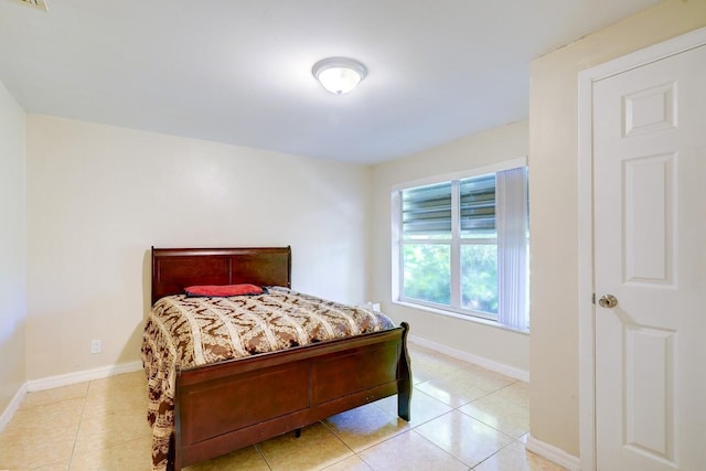 bedroom with visible vents, baseboards, and light tile patterned floors