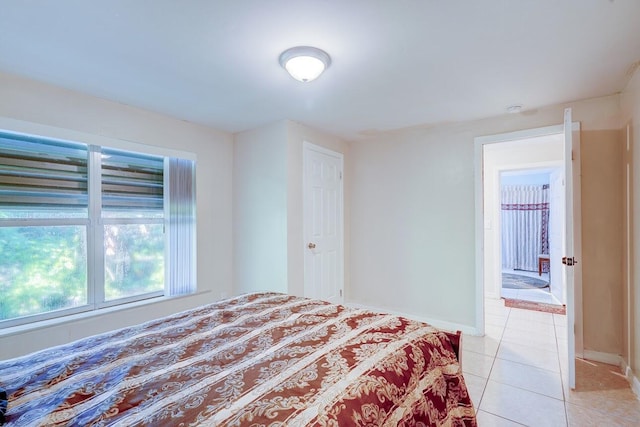 unfurnished bedroom featuring baseboards and light tile patterned flooring