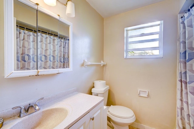 bathroom featuring toilet and vanity