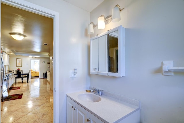 bathroom featuring visible vents, tile patterned flooring, and vanity