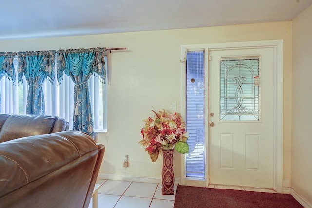 foyer featuring baseboards and light tile patterned floors