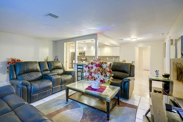 living room featuring visible vents and light tile patterned floors