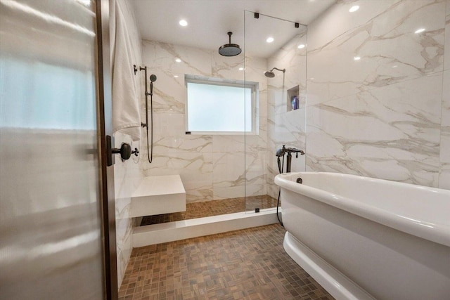 bathroom featuring separate shower and tub and tile walls