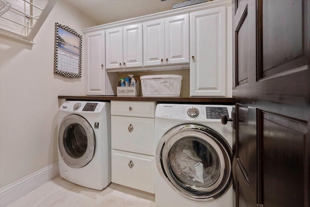 laundry area featuring independent washer and dryer and cabinets